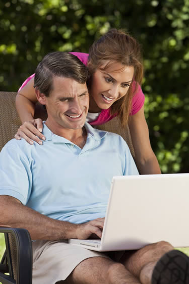 Couple using real estate exam prep tools on computer